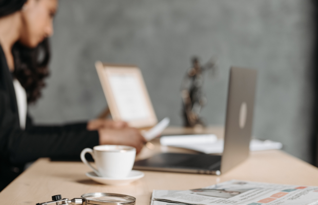lawyer working on laptop with mug of coffee